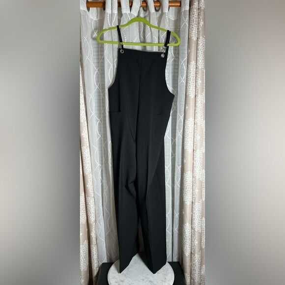 Black in charge 1 piece romper. Size is cut off but looks to be a large. - Picture 1 of 8